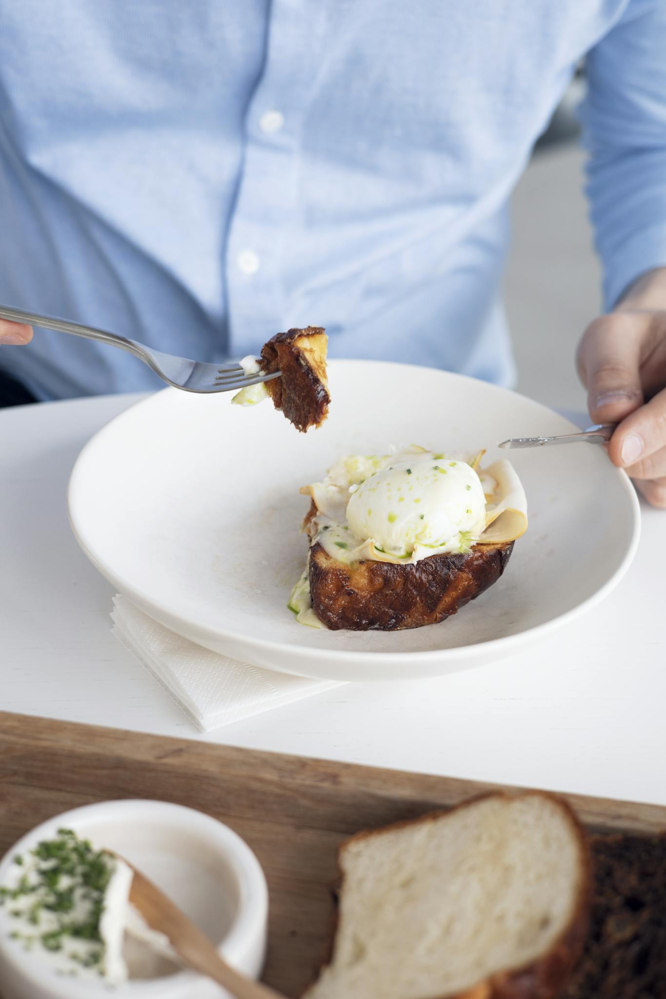 Savor a poached egg delicately placed on crispy toast, a fine dining experience.