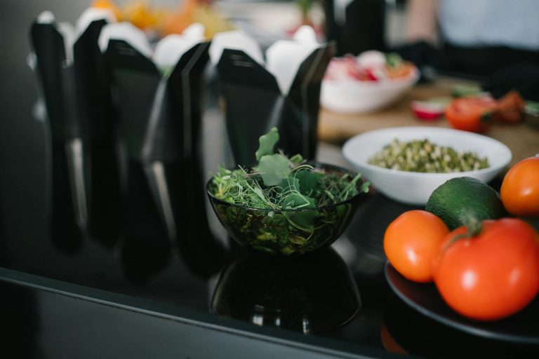 Close-up of fresh vegetables and takeout containers in a kitchen setting.